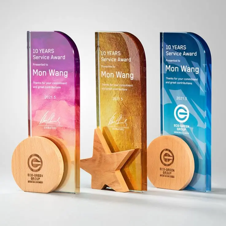 Colorful customized acrylic service awards with wooden bases and decorative accents
